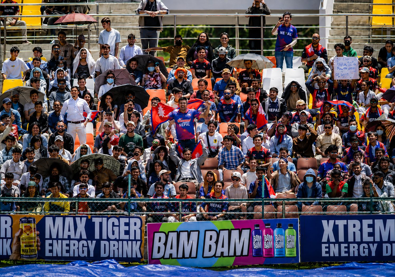 Nepal cricket supporters above Max Tiger stadium branding