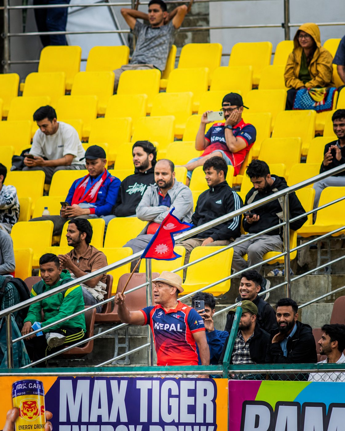 Nepal cricket supporters beside Max Tiger stadium branding